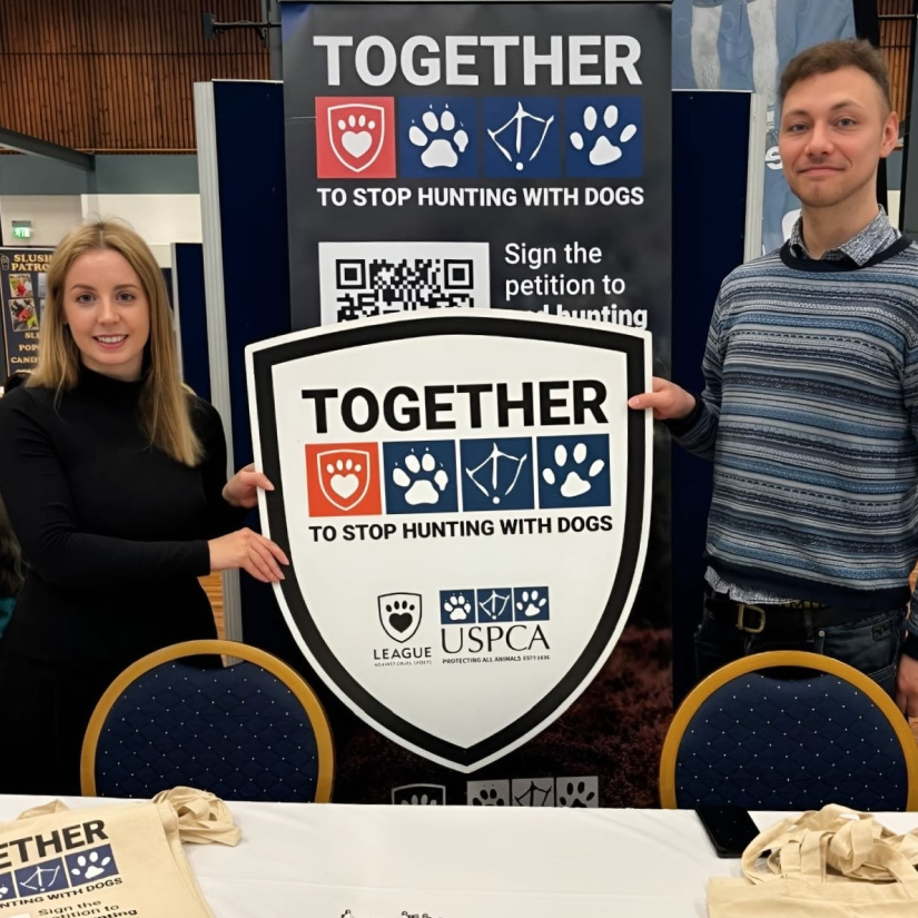 Woman and man holding sign